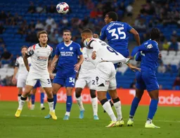 Andy Rinomhota heads the ball away from Carlton Morris