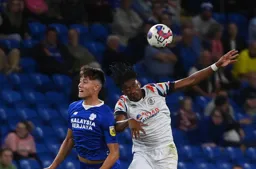 Gabriel Osho and Perry Ng challenge for a high ball