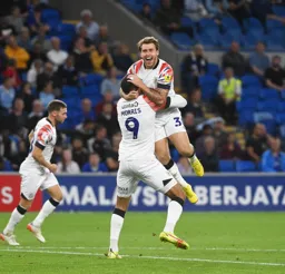 Carlton Morris gives Luke Freeman a lift after Freeman had scored the Town`s first goal