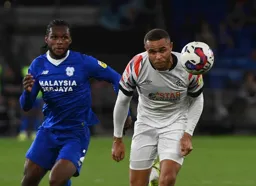 Carlton Morris leads a race for the ball