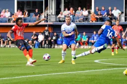 Curtis Tilt throws himself at the ball as Gabriel Osho takes a shot at goal