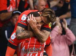 Luke Freeman gives Carlton Morris a hug after scoring the Town`s only goal