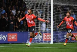 Carlton Morris shows his delight after scoring his and Town`s first goal. Luke Freeman looks equally pleased