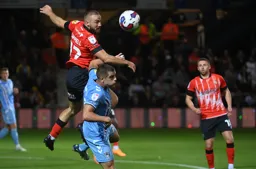 Allan Campbell heads the ball forward