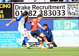 Tom lockyer shields the ball