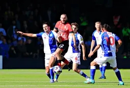 Allan Campbell is outnumbered but comes through with the ball