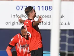 Reece Burke takes in the acclaim after scoring his goal