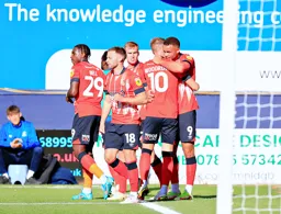 Carlton Morris gives Cauley Woodrow a hug after scoring the first goal