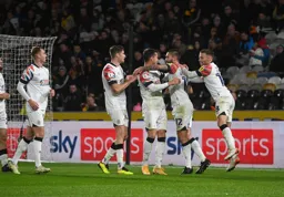 Henri Lansbury celebrates his goal with some happy team mates
