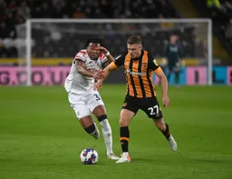 Gabriel Osho and Regan Slater jostle to get possession of the ball