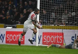 Henri Lansbury carries the ball away after scoring Town`s second goal