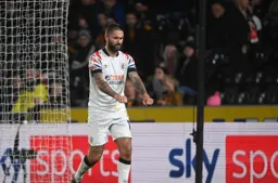 Henri Lansbury does his lawnmower enactment after scoring Town`s second goal