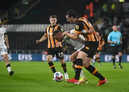 Carlton Morris grapples for the ball with Jacob Greaves