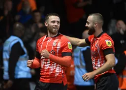 Jordan Clark and Allan Campbell look pleased after Clark has netted the Town`s third goal
