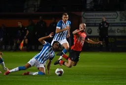 Allan Campbell is sent crashing to the ground by David Kasumu