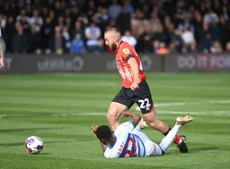 Allan Campbell takes the ball away from a grounded Kenneth Paal