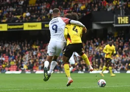 Carlton Morris has his arm wrapped around Hamza Choudhury