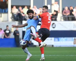 Sonny Bradley tussles for the ball against Ellis Simms