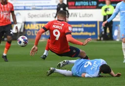 Carlton Morris and Danny Batth go to ground