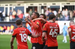 Carlton Morris gets a pat on the back from Jordan Clark