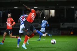 Elijah Adebayo trys to get past the out stretched leg of Andy Yiadom