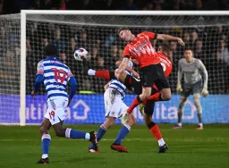 Carlton Morris knocks the ball away from Dan Potts