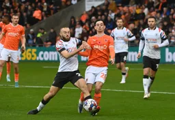 Allan Campbell fights for possession against Charlie Patino