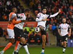 Carlton Morris and Harry Cornick both try to win the ball