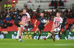 Harry Cornick shoots and Ben Willmot attempts to make a block
