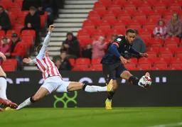 Carlton Morris takes a shot at goal despite Harry Clarke`s best efforts to block it