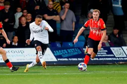 Cohen Bramall clears the ball before James Bree can intervene