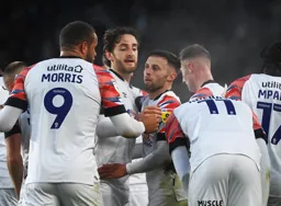 Jordan Clark is mobbed by his team mates after scoring the Town`s only goal