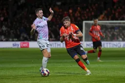 Alfie Doughty takes the ball around Kenny McLean