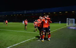 Carlton Morris is mobbed by his team mates after scoring his and the Town`s second goal