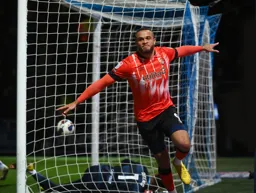 Carlton Morris wheels away in triumph after scoring his and the Town`s second goal of the evening
