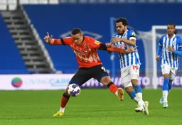 Carlton Morris holds off Duane Holmes