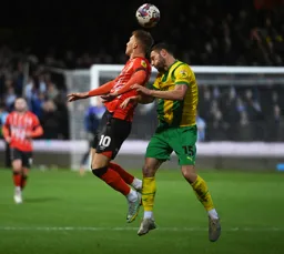 Cauley Woodrow and Erik Pieters compete for the ball