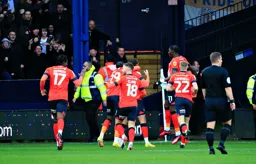 Carlton Morris is mobbed by his team mates after scoring the first goal