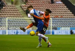Gabriel Osho and Callum Lang fight for possession of the ball