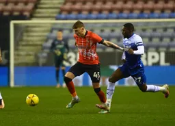 Alfie Doughty is closed down by Tendayi Darikwa