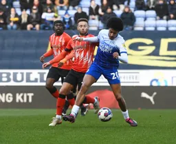 Miguel Azeez shields the ball away from Jordan Clark