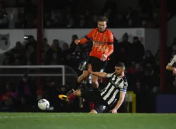 Luke Waterfall knocks the ball away from Luke Berry
