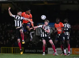 Gabriel Osho gets above two defenders to send a header towards goal