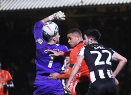 Carlton Morris heads the ball behind Max Crocombe but with no result