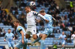 Kyle McFadzean heads the ball clear from Carlton Morris