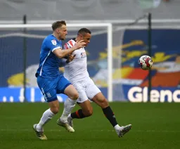 Carlton Morris holds off his marker