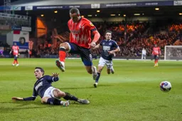 Carlton Morris looks like he is about to stamp on a Millwall defender