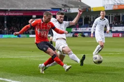 Jordan Clark passes the ball across the penalty area