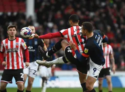 Carlton Morris and Max Lowe go in with raised boots