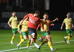 Carlton Morris trys to force his way past Zak Vyner